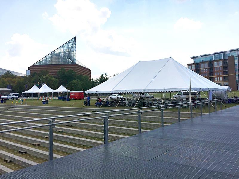 Tent manufacturers setting up for an event.